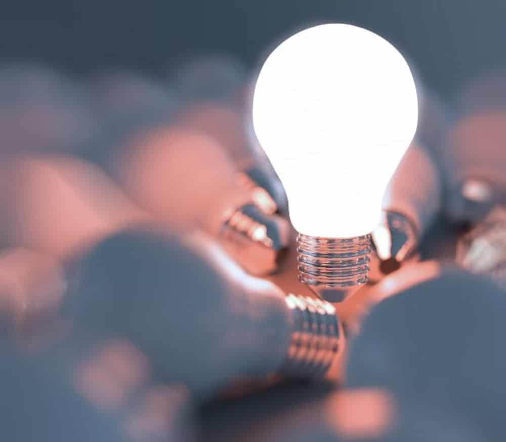 Image of light bulbs and one lit up
