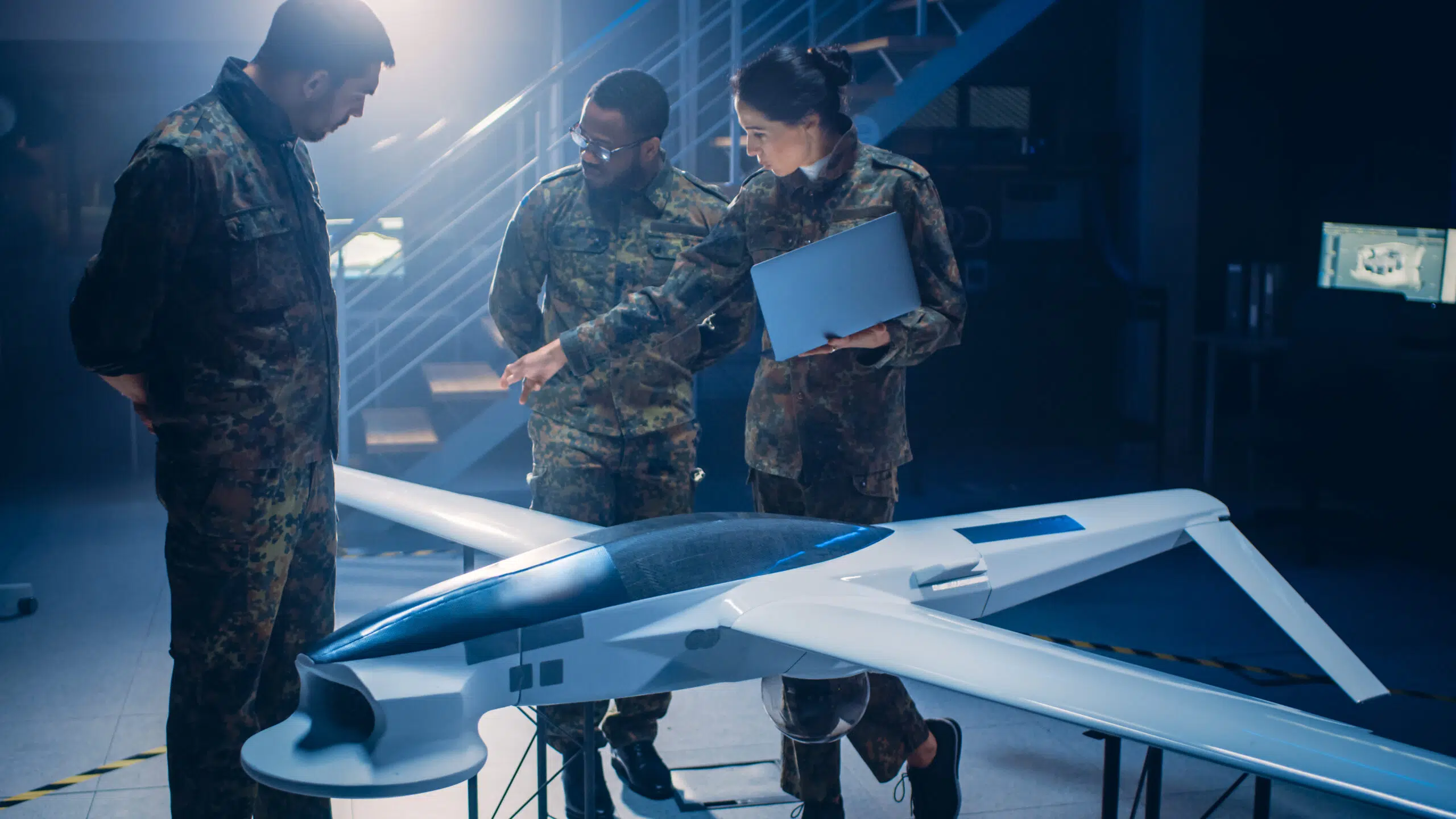 Army,Aerospace,Engineers,Work,On,Unmanned,Aerial,Vehicle,/,Drone. Army engineers looking at an engineering model