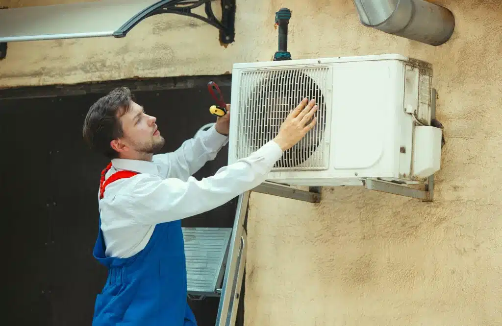 Image of a man with an air conditioning unit