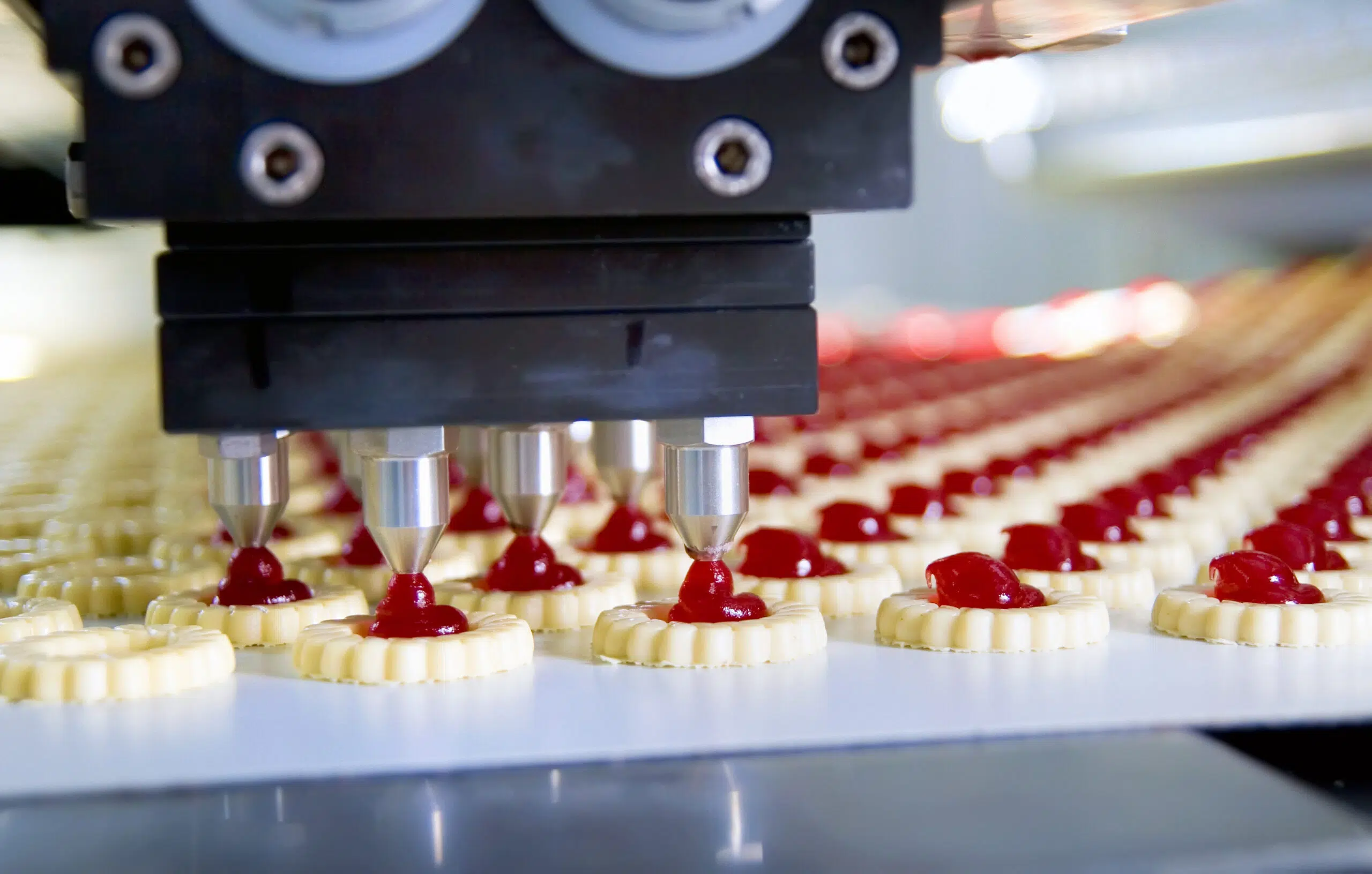 Food and drink manufacturing with robotic nozzles filling jam biscuits