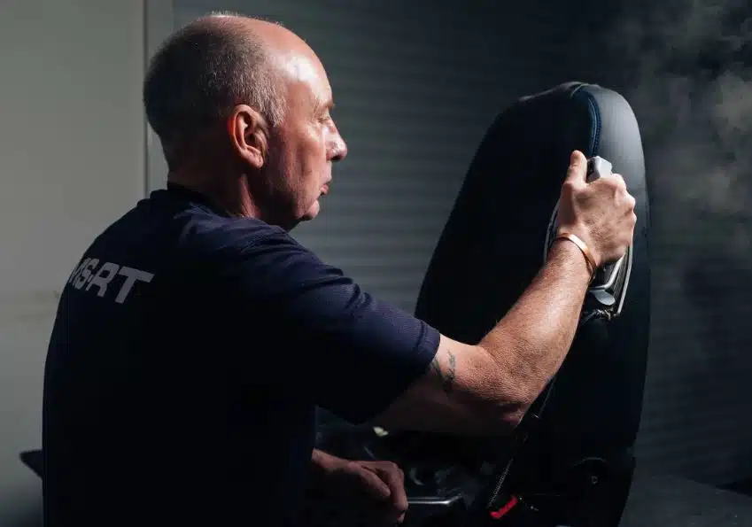 MSRT worker finishing upholstery of car seat