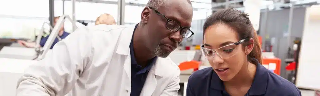 Image of man and woman looking at something in lab