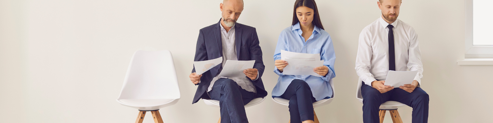 three people waitin for interview and reading their notes