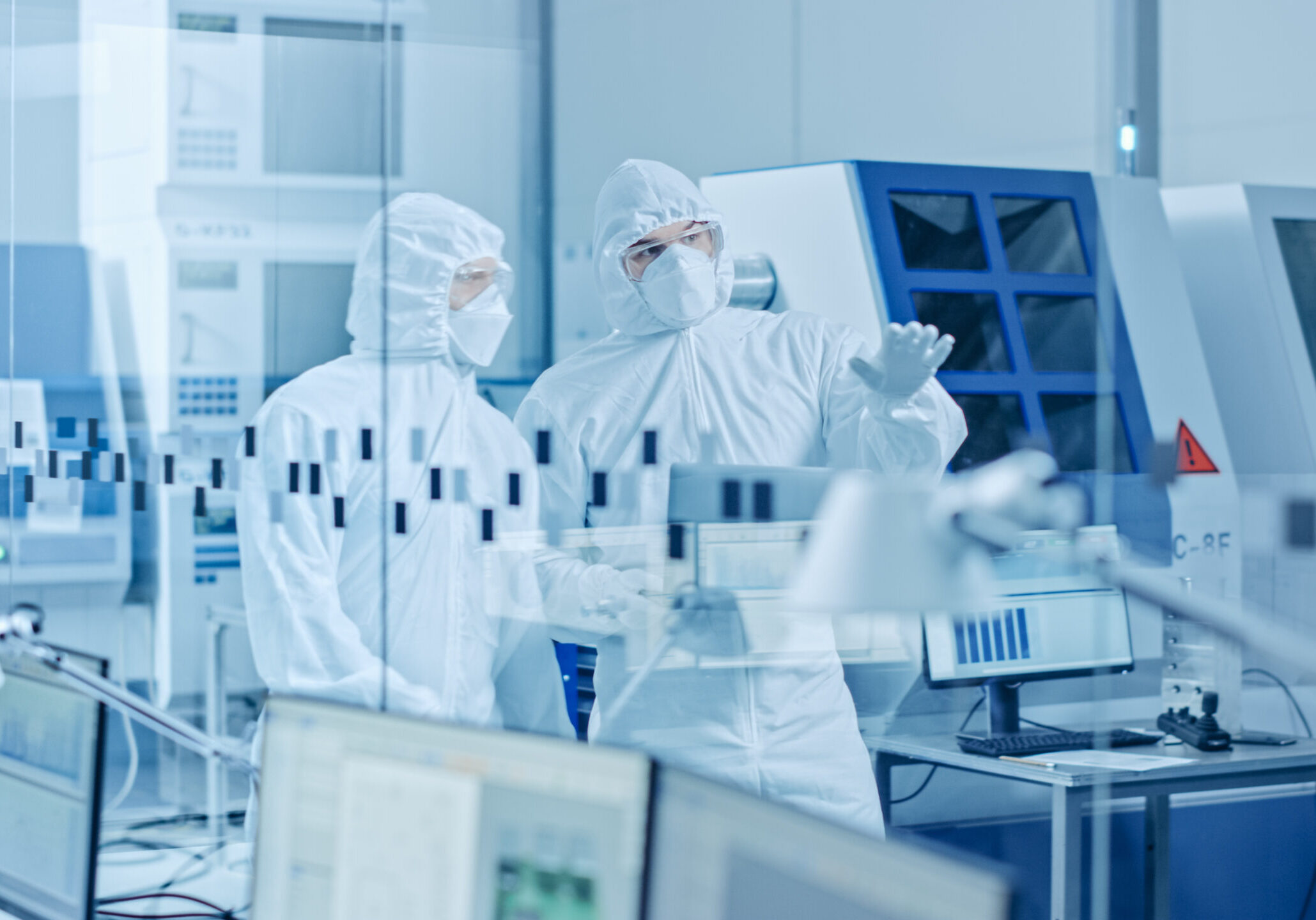 Image of two men in hazmat suits in a laboratory for health and safety