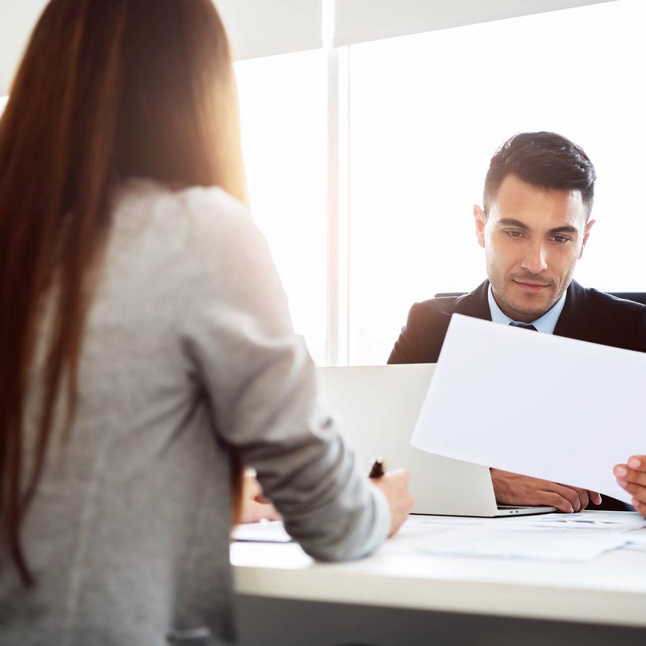 Man and woman looking at cv Man and woman looking at cv