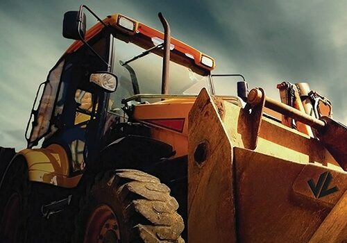 Image of a off highway backhoe loader with Jon Lee Logo on it